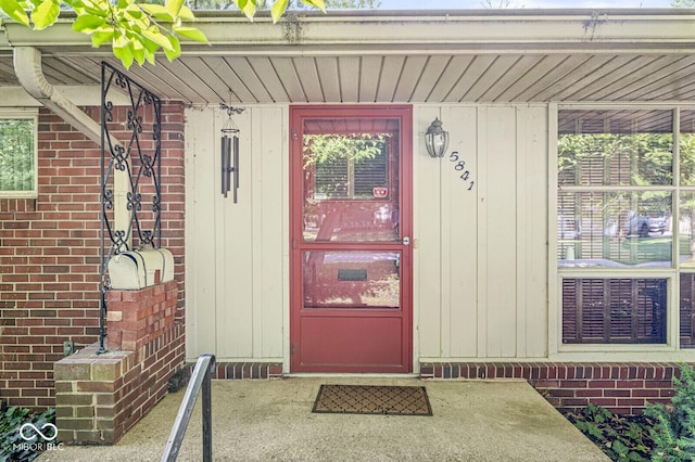 5841 N Parker Ave, Indianapolis, IN 46220 - doorway to property featuring brick siding and board and batten siding