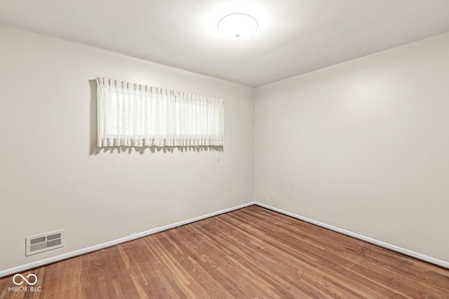 5841 N Parker Ave, Indianapolis, IN 46220 - spare room featuring baseboards and wood finished floors