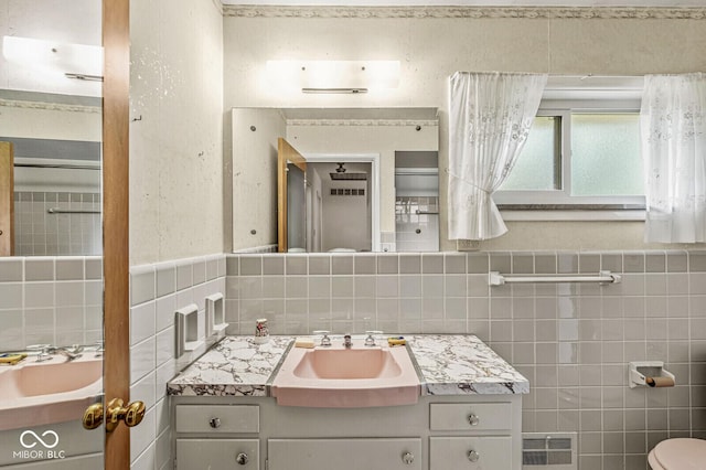 5841 N Parker Ave, Indianapolis, IN 46220 - bathroom with tile walls, vanity, and a wainscoted wall