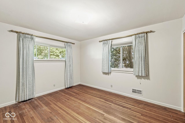 5841 N Parker Ave, Indianapolis, IN 46220 - empty room with baseboards and wood finished floors