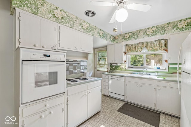 5841 N Parker Ave, Indianapolis, IN 46220 - kitchen featuring white appliances, light countertops, light floors, a ceiling fan, and white cabinetry