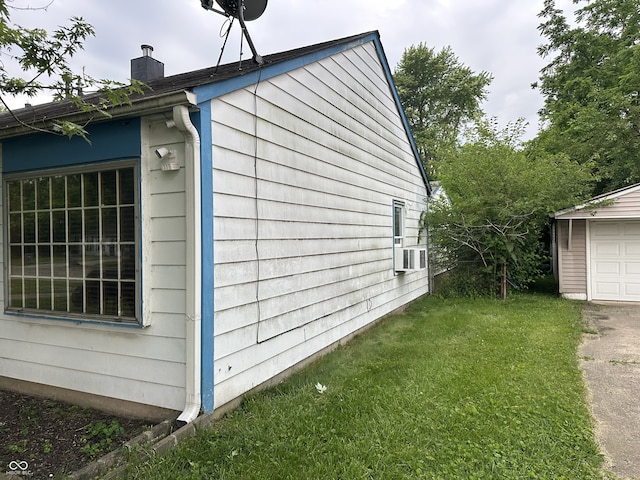 3440 Brewer Dr, Indianapolis, IN 46222 - view of home's exterior with a chimney, a lawn, cooling unit, and a garage