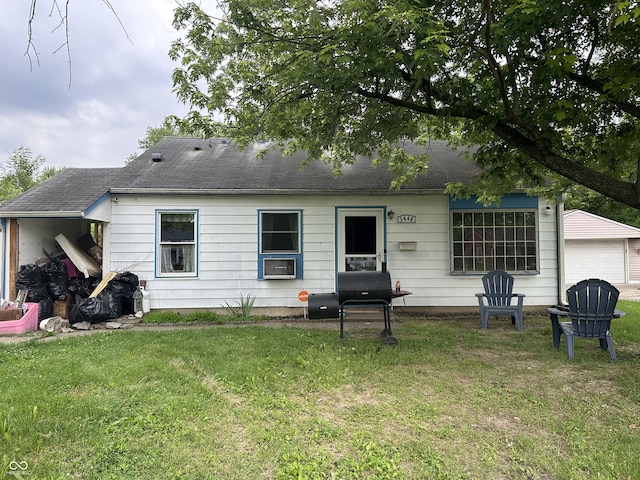 3440 Brewer Dr, Indianapolis, IN 46222 - back of property featuring a yard and a garage