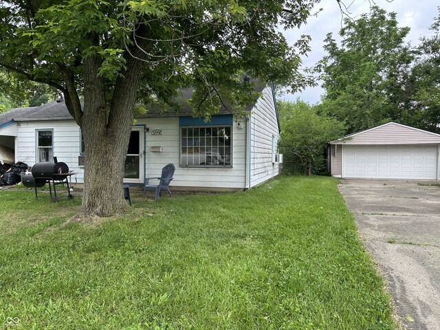 3440 Brewer Dr, Indianapolis, IN 46222 - view of front of property featuring a garage, a front lawn, and an outbuilding
