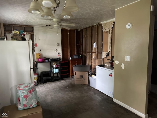3440 Brewer Dr, Indianapolis, IN 46222 - kitchen featuring freestanding refrigerator, a ceiling fan, a textured ceiling, and concrete flooring