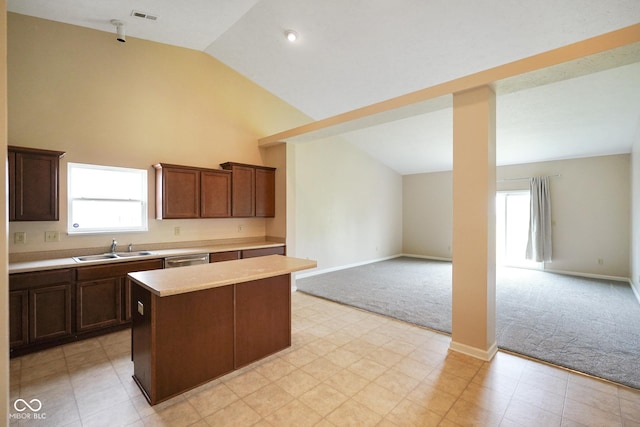 7715 Bolero Dr, Camby, IN 46113 - kitchen with light colored carpet, a center island, light countertops, high vaulted ceiling, and open floor plan