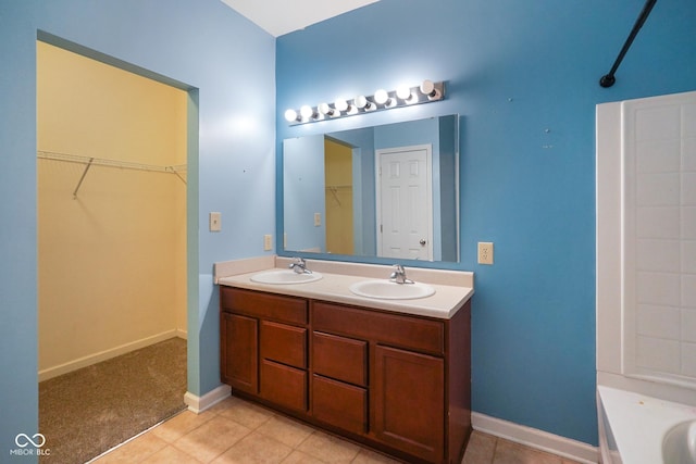 7715 Bolero Dr, Camby, IN 46113 - bathroom with double vanity, a tub, a spacious closet, and tile patterned floors