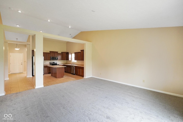 7715 Bolero Dr, Camby, IN 46113 - unfurnished living room featuring light colored carpet and vaulted ceiling