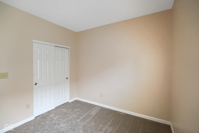 7715 Bolero Dr, Camby, IN 46113 - unfurnished bedroom featuring dark carpet and a closet