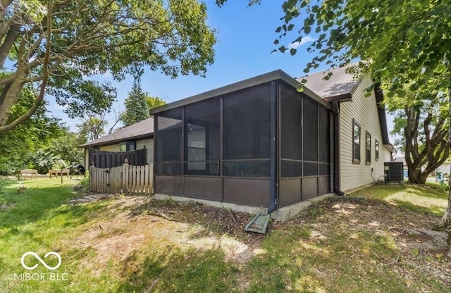 7616 Derrek Pl, Indianapolis, IN 46219 - view of side of home featuring a sunroom and a lawn