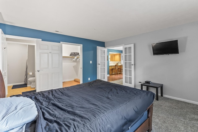 7616 Derrek Pl, Indianapolis, IN 46219 - bedroom with french doors, a spacious closet, and ensuite bath