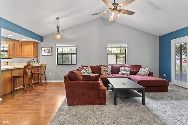 7616 Derrek Pl, Indianapolis, IN 46219 - living room featuring lofted ceiling, plenty of natural light, light wood-type flooring, and a ceiling fan