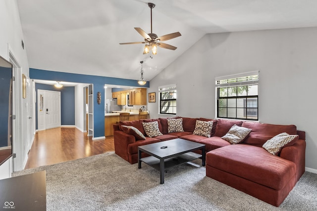 7616 Derrek Pl, Indianapolis, IN 46219 - living area with ceiling fan, high vaulted ceiling, light colored carpet, and light wood-style floors