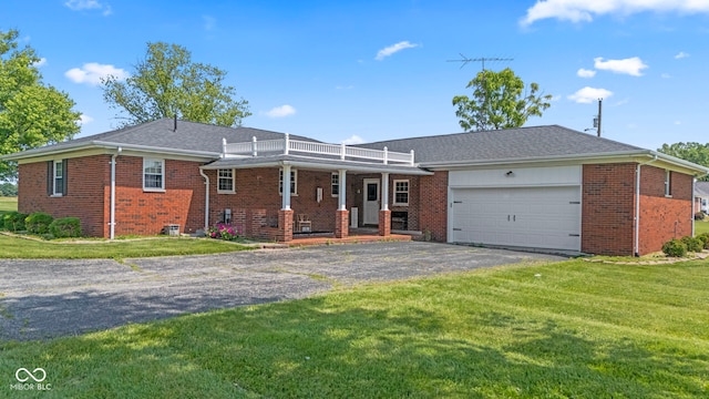 3249 N Slab Rd, Austin, IN 47102 - view of front of house featuring driveway, a garage, brick siding, and a front lawn