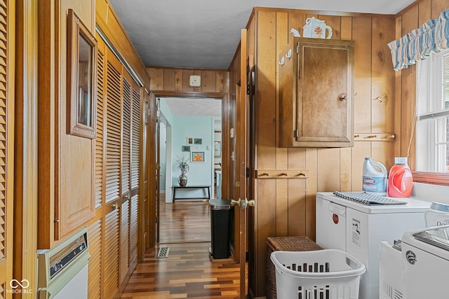 3249 N Slab Rd, Austin, IN 47102 - laundry room featuring independent washer and dryer, cabinet space, wood finished floors, wooden walls, and a textured ceiling