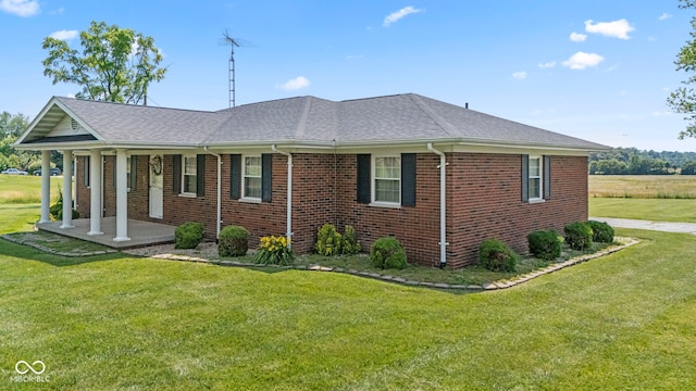 3249 N Slab Rd, Austin, IN 47102 - view of property exterior with a porch, a yard, a shingled roof, and brick siding