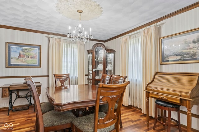 3249 N Slab Rd, Austin, IN 47102 - dining space featuring wallpapered walls, wood finished floors, ornamental molding, a chandelier, and plenty of natural light