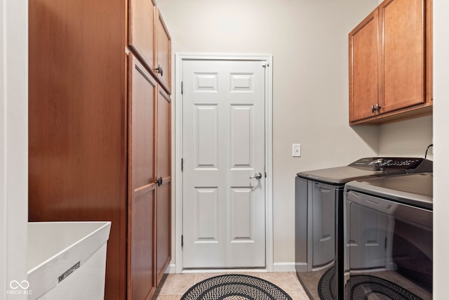 13327 Hockley Dr, Fishers, IN 46037 - laundry area with cabinet space, washer and clothes dryer, and light tile patterned floors