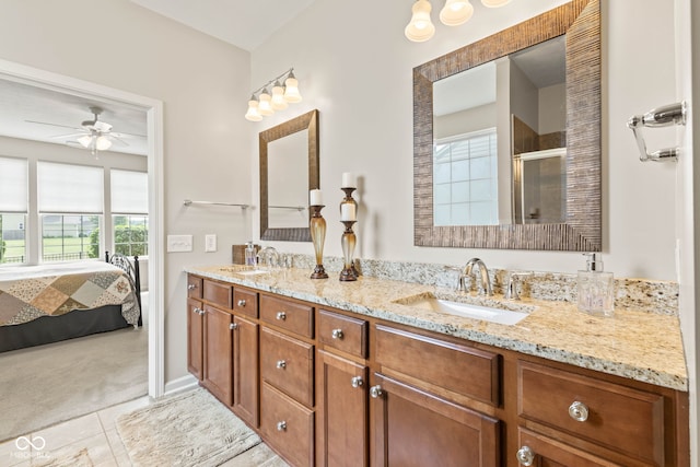 13327 Hockley Dr, Fishers, IN 46037 - ensuite bathroom featuring double vanity, a stall shower, a ceiling fan, and tile patterned flooring