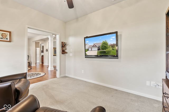 13327 Hockley Dr, Fishers, IN 46037 - carpeted living area with decorative columns and a ceiling fan