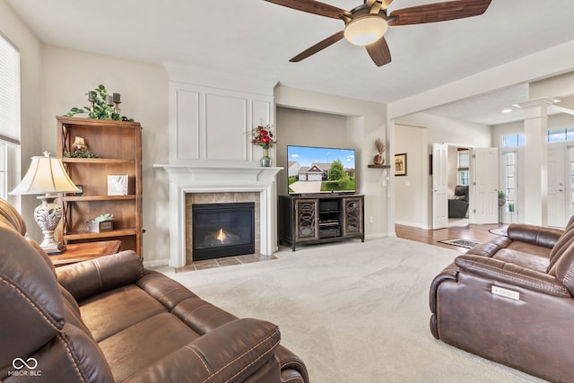 13327 Hockley Dr, Fishers, IN 46037 - carpeted living area featuring ceiling fan, a fireplace, plenty of natural light, and ornate columns