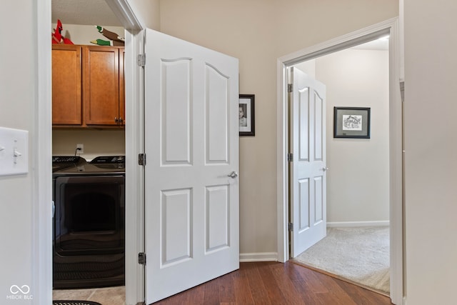 13327 Hockley Dr, Fishers, IN 46037 - washroom featuring dark wood-style floors, cabinet space, and separate washer and dryer
