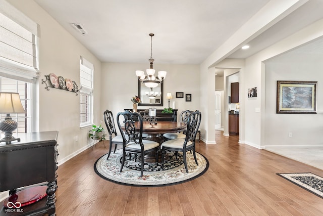 13327 Hockley Dr, Fishers, IN 46037 - dining area featuring a chandelier, wood finished floors, and recessed lighting