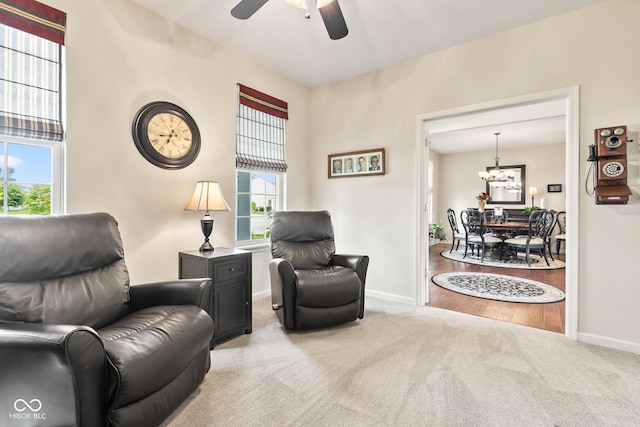 13327 Hockley Dr, Fishers, IN 46037 - living area with carpet floors, a chandelier, and a ceiling fan