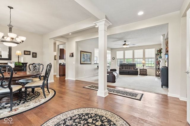 13327 Hockley Dr, Fishers, IN 46037 - dining space featuring ornate columns, ceiling fan, wood finished floors, recessed lighting, and a chandelier
