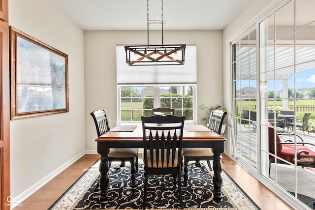 13327 Hockley Dr, Fishers, IN 46037 - dining area featuring light wood-type flooring, plenty of natural light, and a chandelier