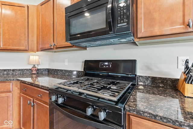 13327 Hockley Dr, Fishers, IN 46037 - kitchen with black appliances, dark stone countertops, and brown cabinets