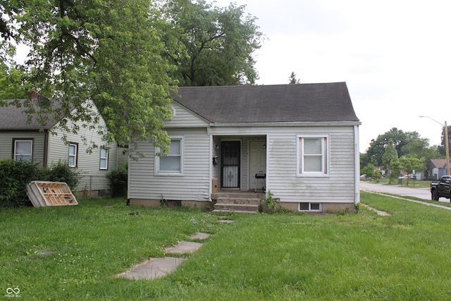 1703 E 34th St, Indianapolis, IN 46218 - view of front of home with a front lawn and roof with shingles