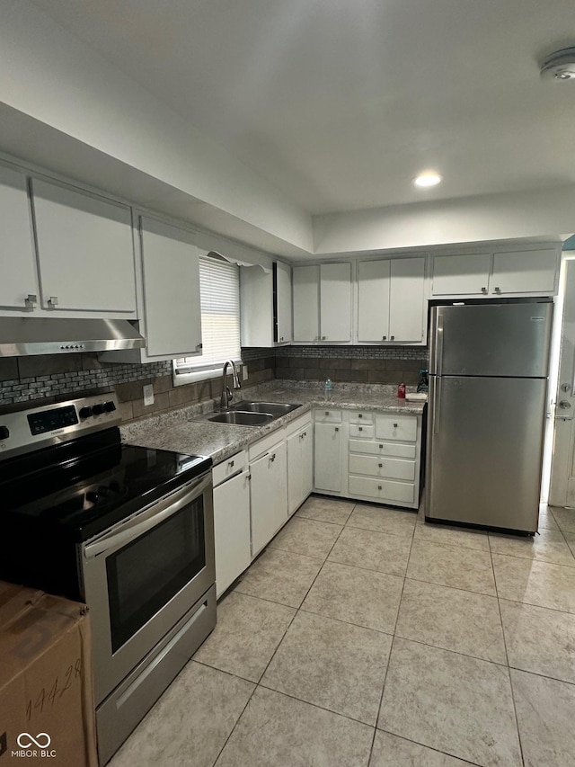 4908 Elmhurst Dr, Indianapolis, IN 46226 - kitchen with stainless steel appliances, under cabinet range hood, backsplash, light tile patterned floors, and recessed lighting