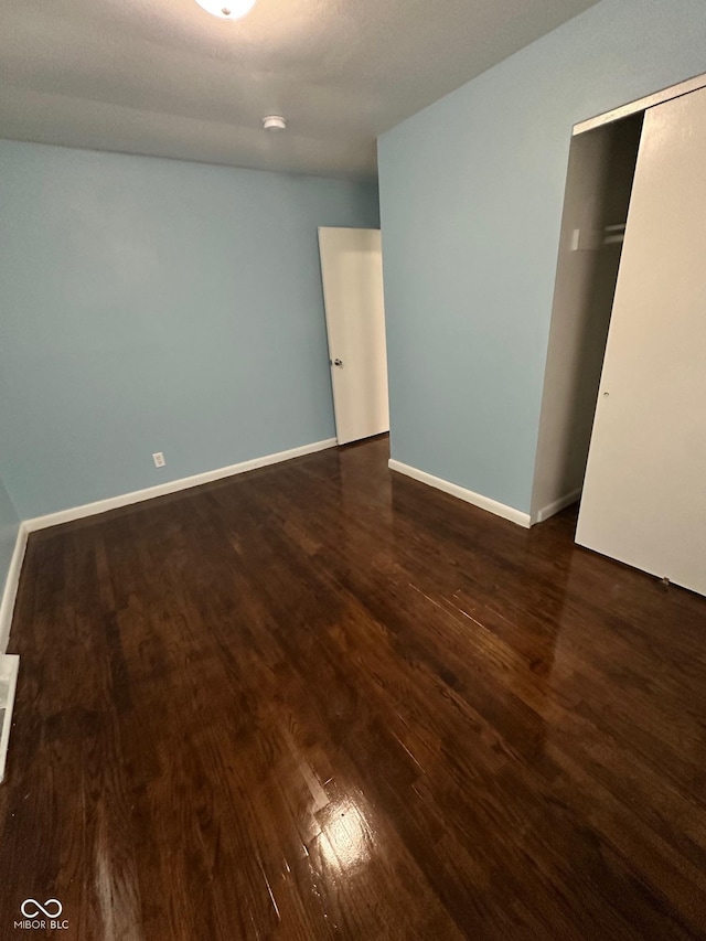 4908 Elmhurst Dr, Indianapolis, IN 46226 - unfurnished bedroom featuring dark wood-style flooring and a closet