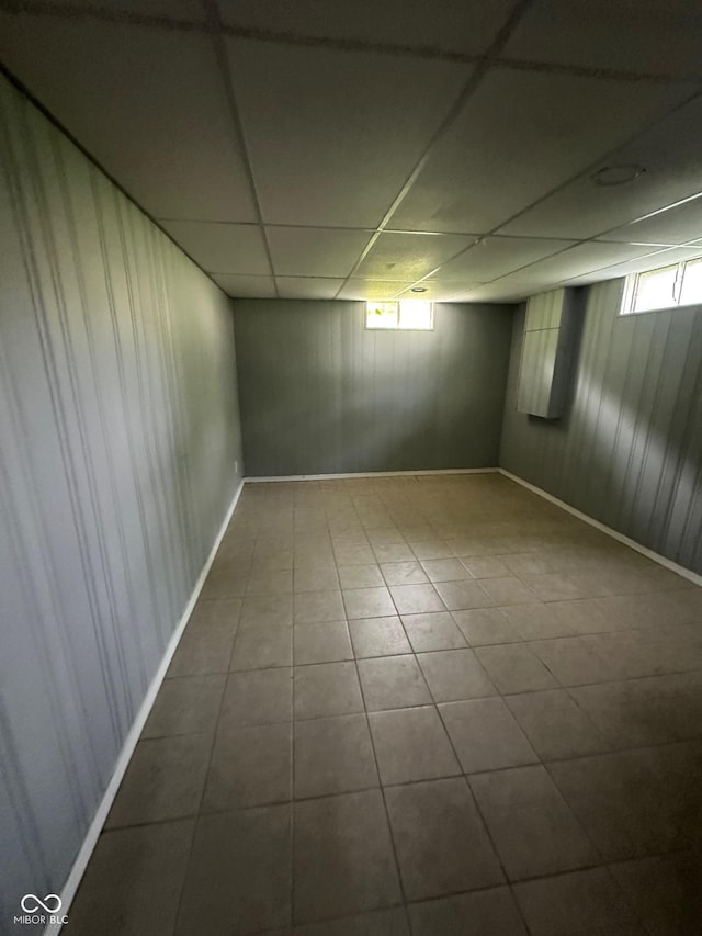 4908 Elmhurst Dr, Indianapolis, IN 46226 - basement featuring tile patterned flooring, wooden walls, and a paneled ceiling