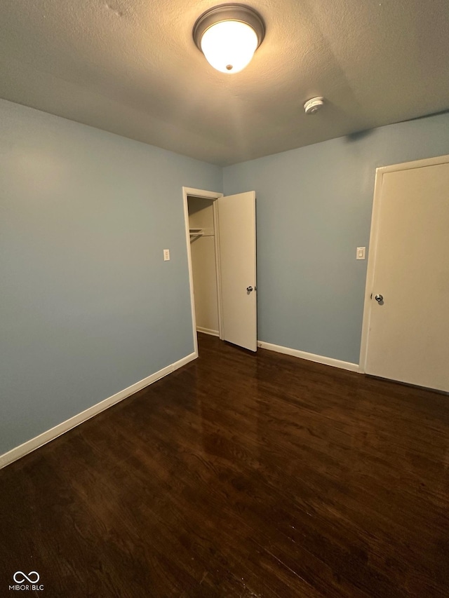 4908 Elmhurst Dr, Indianapolis, IN 46226 - spare room featuring a smoke detector, wood finished floors, and a textured ceiling