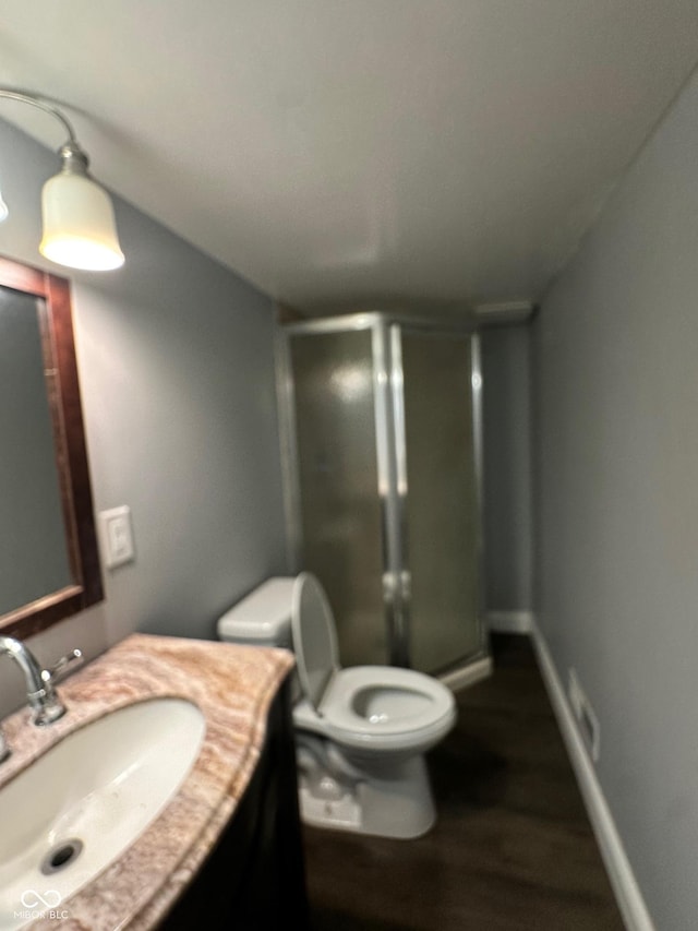 4908 Elmhurst Dr, Indianapolis, IN 46226 - bathroom featuring vanity, a stall shower, and wood finished floors