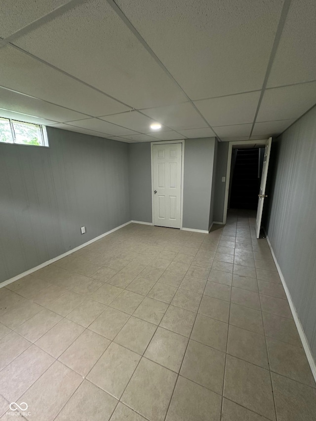 4908 Elmhurst Dr, Indianapolis, IN 46226 - basement featuring light tile patterned floors and a paneled ceiling