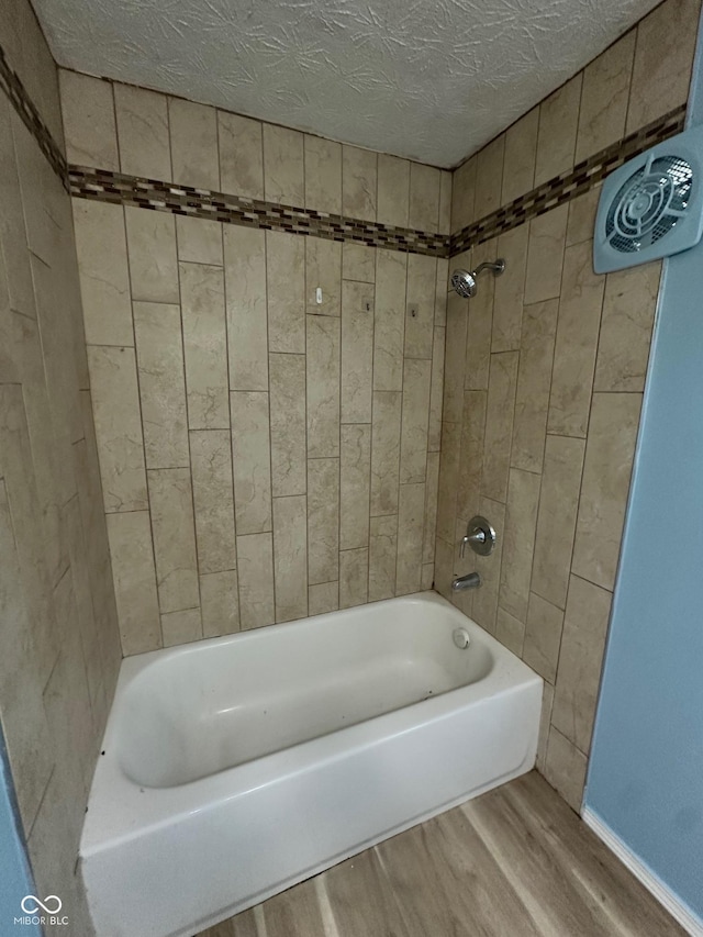 4908 Elmhurst Dr, Indianapolis, IN 46226 - full bath with wood finished floors, bathing tub / shower combination, and a textured ceiling