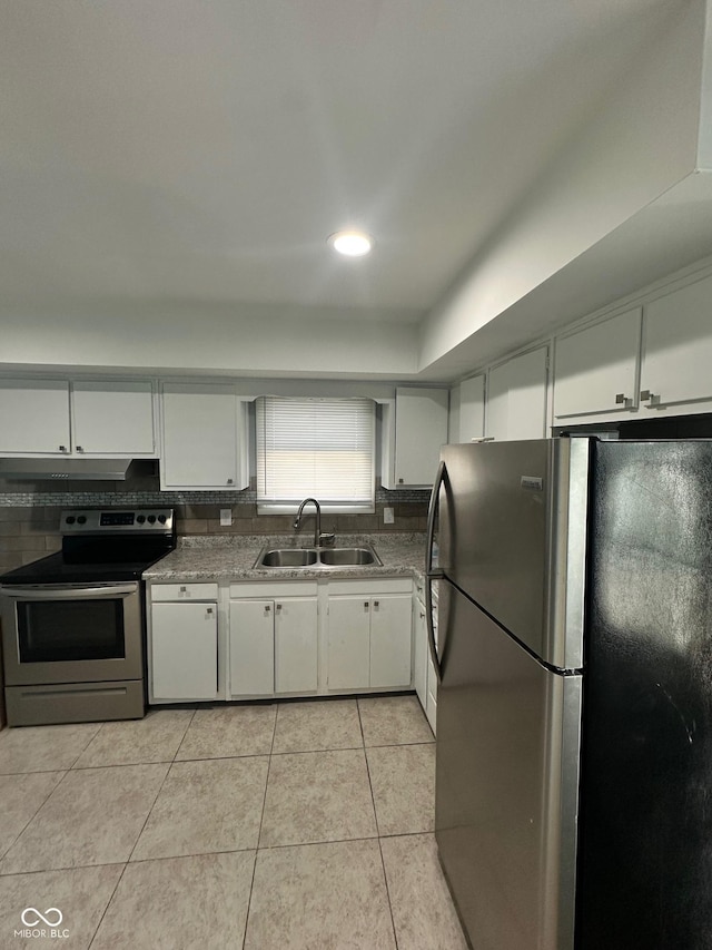 4908 Elmhurst Dr, Indianapolis, IN 46226 - kitchen featuring stainless steel appliances, under cabinet range hood, light tile patterned flooring, and white cabinetry