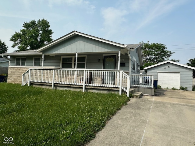 4908 Elmhurst Dr, Indianapolis, IN 46226 - single story home with covered porch, driveway, an outbuilding, and a garage