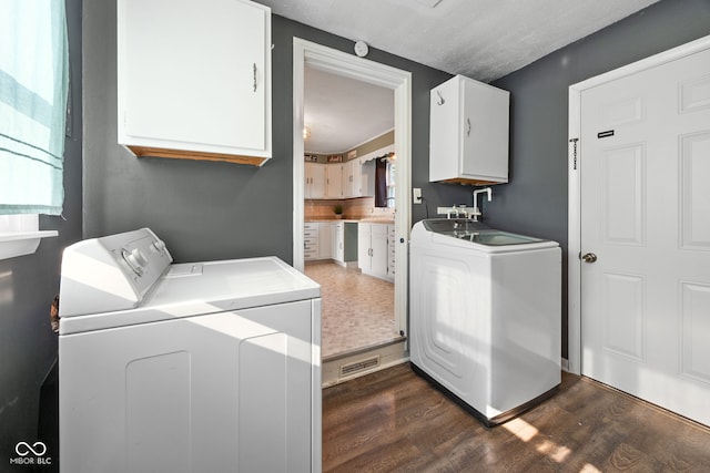900 N College St N, Veedersburg, IN 47987 - laundry area featuring cabinet space, washing machine and clothes dryer, and dark wood-style floors