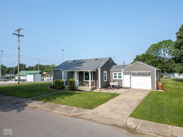 900 N College St N, Veedersburg, IN 47987 - view of front of property featuring a front lawn, an outdoor structure, concrete driveway, and a shingled roof