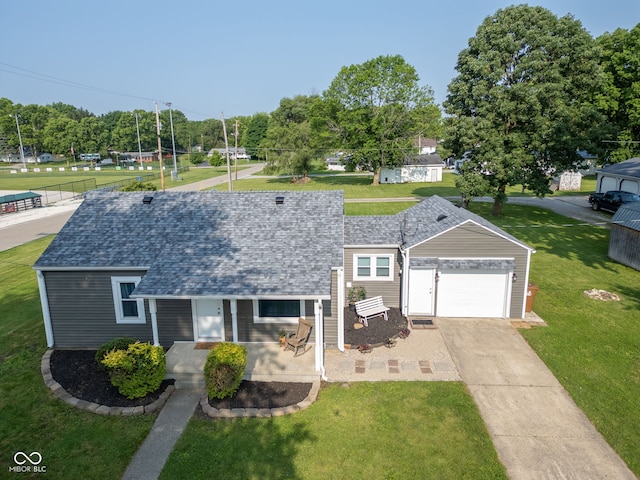 900 N College St N, Veedersburg, IN 47987 - view of front of home with concrete driveway, a garage, a front lawn, and roof with shingles