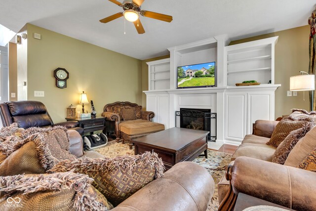 705 Ridge Gate Dr, Brownsburg, IN 46112 - living room featuring a glass covered fireplace, a ceiling fan, and built in shelves