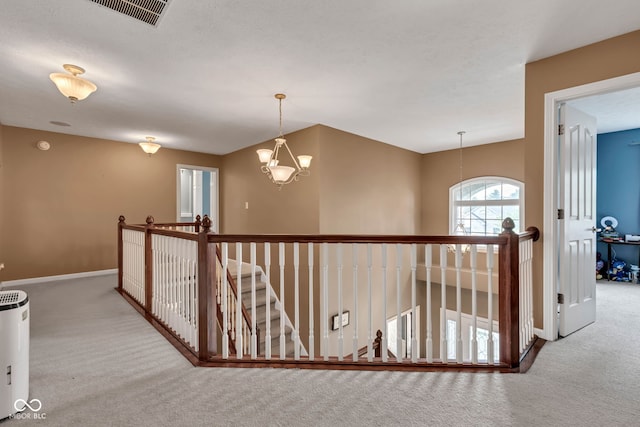 705 Ridge Gate Dr, Brownsburg, IN 46112 - hallway featuring carpet flooring, an upstairs landing, and a chandelier