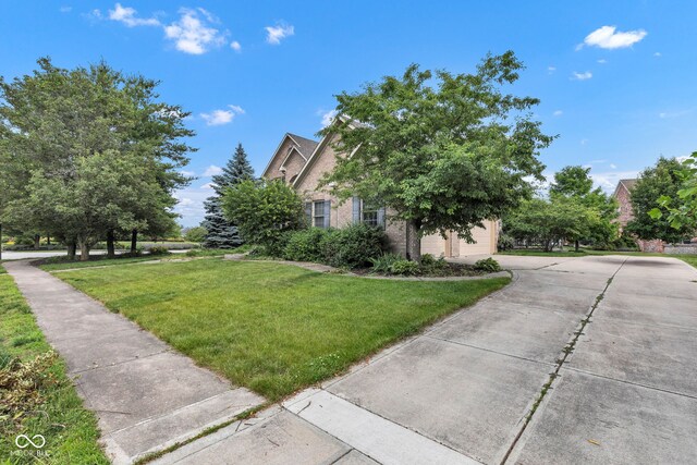 705 Ridge Gate Dr, Brownsburg, IN 46112 - view of property exterior with a lawn, concrete driveway, and brick siding