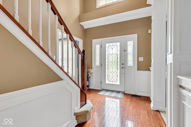 705 Ridge Gate Dr, Brownsburg, IN 46112 - foyer entrance featuring wainscoting, stairway, light wood-type flooring, and a decorative wall
