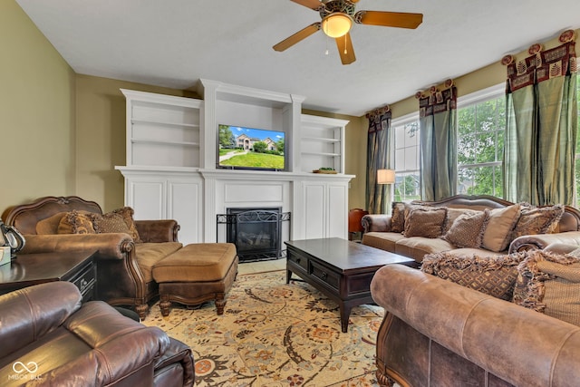 705 Ridge Gate Dr, Brownsburg, IN 46112 - living area with a ceiling fan, a glass covered fireplace, and built in shelves