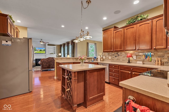 705 Ridge Gate Dr, Brownsburg, IN 46112 - kitchen featuring appliances with stainless steel finishes, ceiling fan, light wood-type flooring, open floor plan, and light countertops